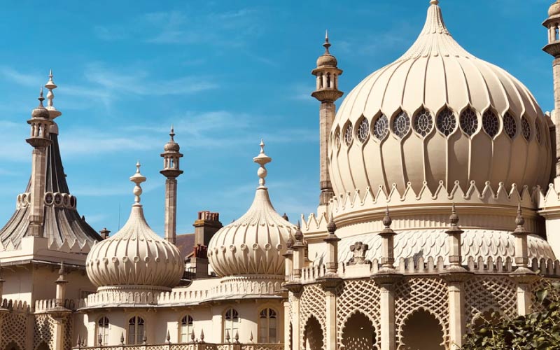 Exterior view of the Royal Pavilion in Brighton, featuring its iconic domes and minarets.